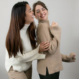 Frauen lachen glücklich mit ihrem warmen Alpaka Rollkragenpullover aus 100% reiner Babyalpaka Wolle